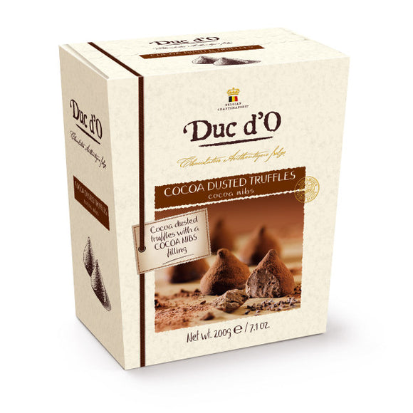 Dusted truffles with filling and cocoa nibs packed in a gift box. Brand:Duc d’O, Belgium.