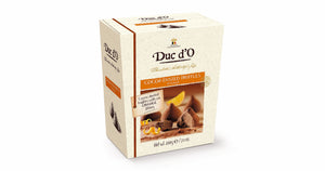 Dusted truffles with filling and orange pieces packed in a gift box. Brand:Duc d’O, Belgium.